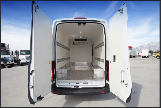 Open rear doors of a refrigerated van showing a white sanitary cargo area, ceiling evaporator, and tie-down rails